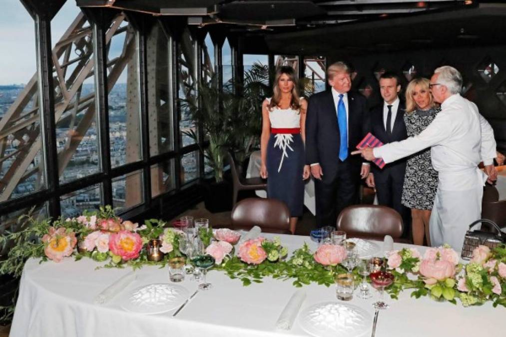 French Chef Alain Ducasse (R) welcomes French President Emmanuel Macron (3rd R), his wife Brigitte Macron (2nd R), US President Donald Trump (2nd L) and First Lady Melania Trump (L) upon their arrival for a dinner at Le Jules Verne Restaurant on the Eiffel Tower in Paris, on July 13, 2017 as part of US president's 24-hour trip that coincides with France's national day and the 100th anniversary of US involvement in World War I.<br/>Donald Trump arrived in Paris for a 24-hour trip that coincides with France's national day and the 100th anniversary of US involvement in World War I. / AFP PHOTO / POOL / YVES HERMAN