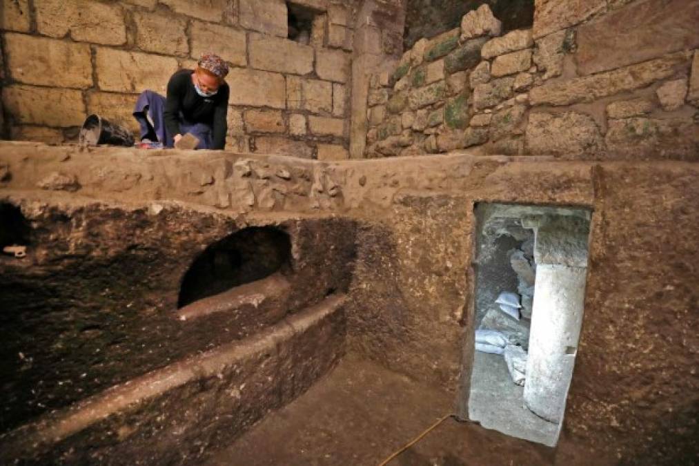 Tehila Sadiel, an archaeologist of the Israel Antiquities Authority, worsk at an excavation at a subterranean system hewn in the bedrock beneath a 1400-year-old building near the Western Wall in Jerusalem's Old City, on May 19, 2020. (Photo by MENAHEM KAHANA / AFP)