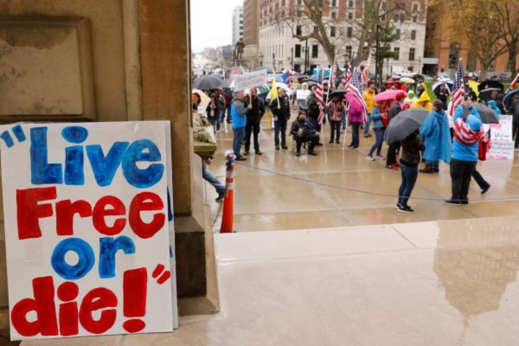 Demonstrators take part in an 'American Patriot Rally,' organized on April 30, 2020, by Michigan United for Liberty on the steps of the Michigan State Capitol in Lansing, demanding the reopening of businesses. - The group is upset with Michigan Gov. Gretchen WhitmerÕs mandatory closure to curtail Covid-19. (Photo by JEFF KOWALSKY / AFP)