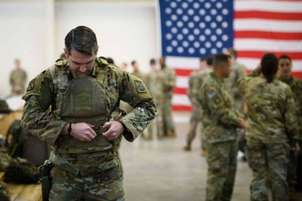 FORT BRAGG, NC - JANUARY 04: U.S. troops from the Army's 82nd Airborne Division wait at Green Ramp before they head out for a deployment to the Middle East on January 4, 2020 in Fort Bragg, North Carolina. Soldiers from the Immediate Response Force of the 82nd are part of the approximately 3,000 troops being deployed as tensions increase with Iran in the region after a U.S. airstrike killed top Iranian General Qasem Soleimani. Andrew Craft/Getty Images/AFP