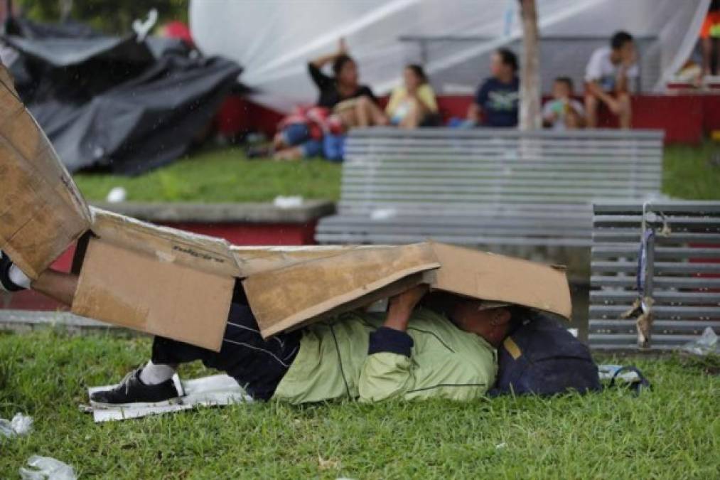 Algunos consiguieron cartones o improvisaron tiendas de campaña para protegerse de la intensa lluvia que azotó anoche ese pequeño poblado.