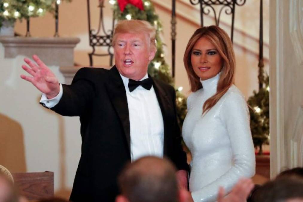 US President Donald Trump and First Lady Melania Trump (R) greet guests during the Congressional Ball at the White House in Washington DC on December 15, 2018. (Photo by ROBERTO SCHMIDT / AFP)