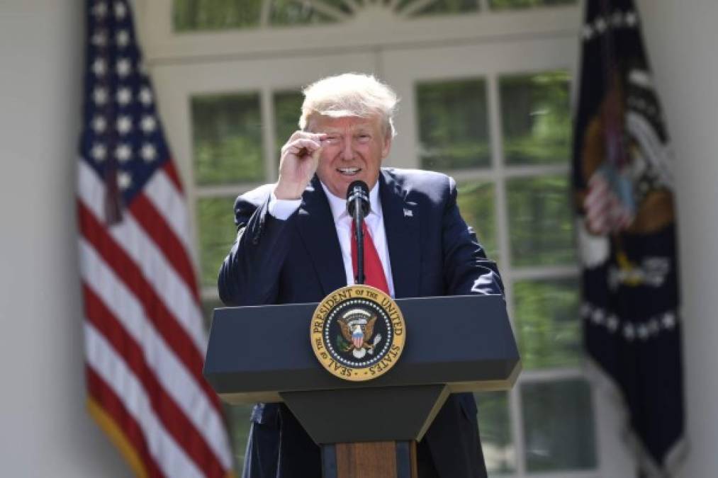 US President Donald Trump announces his decision to withdraw the US from the Paris Climate Accords in the Rose Garden of the White House in Washington, DC, on June 1, 2017. <br/>'As of today, the United States will cease all implementation of the non-binding Paris accord and the draconian financial and economic burdens the agreement imposes on our country,' Trump said. / AFP PHOTO / SAUL LOEB