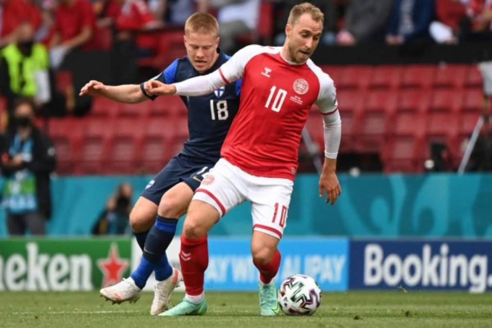 Finland's defender Jere Uronen (L) challenges Denmark's midfielder Christian Eriksen during the UEFA EURO 2020 Group B football match between Denmark and Finland at the Parken Stadium in Copenhagen on June 12, 2021. (Photo by Jonathan NACKSTRAND / POOL / AFP)