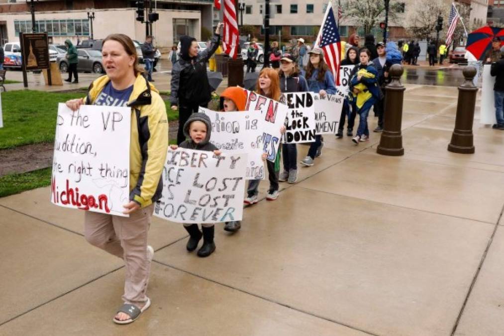 Demonstrators take part in an 'American Patriot Rally,' organized on April 30, 2020, by Michigan United for Liberty on the steps of the Michigan State Capitol in Lansing, demanding the reopening of businesses. - The group is upset with Michigan Gov. Gretchen WhitmerÕs mandatory closure to curtail Covid-19. (Photo by JEFF KOWALSKY / AFP)