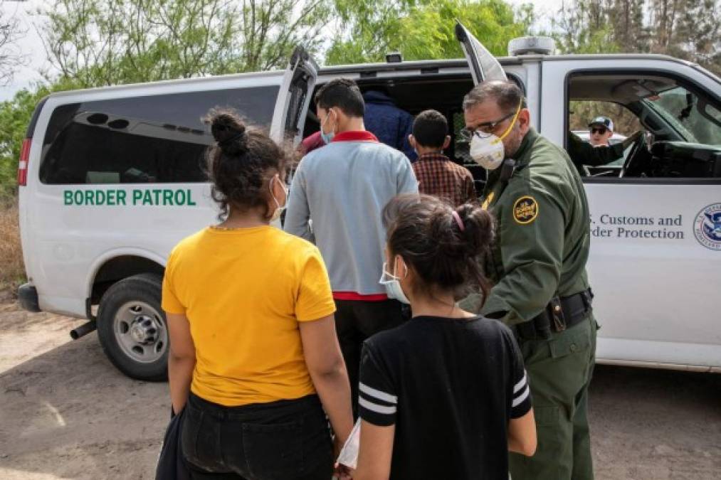 HIDALGO, TEXAS - MARCH 25: Unaccompanied minors are loaded into a U.S. Border Patrol transport van after crossing the U.S.-Mexico border on March 25, 2021 in Hidalgo, Texas. A large group of families and unaccompanied minors, mostly teenagers, came over the Rio Grande onto private property, where Border Patrol agents separated the unaccompanied minors for separate transport. The Biden administration is permitting the minors to stay, whereas many families, especially with older children, are being deported. John Moore/Getty Images/AFP<br/><br/>== FOR NEWSPAPERS, INTERNET, TELCOS & TELEVISION USE ONLY ==<br/><br/>
