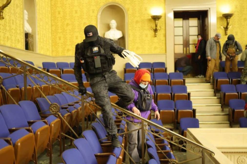 WASHINGTON, DC - JANUARY 06: Protesters enter the Senate Chamber on January 06, 2021 in Washington, DC. Congress held a joint session today to ratify President-elect Joe Biden's 306-232 Electoral College win over President Donald Trump. Pro-Trump protesters have entered the U.S. Capitol building after mass demonstrations in the nation's capital. Win McNamee/Getty Images/AFP<br/><br/>== FOR NEWSPAPERS, INTERNET, TELCOS & TELEVISION USE ONLY ==<br/><br/>