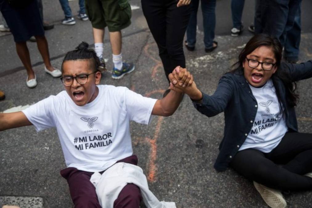 NEW YORK, NY - SEPTEMBER 5: Immigration activists protesting the Trump administration's decision on the Deferred Action for Childhood Arrivals program sit in the street and block traffic on 5th Avenue near Trump Tower, September 5, 2017. On Tuesday, the Trump administration announced they will end the Deferred Action for Childhood Arrivals program, with a six month delay. The decision represents a blow to young undocumented immigrants (also known as 'dreamers') who were shielded from deportation under DACA. Drew Angerer/Getty Images/AFP