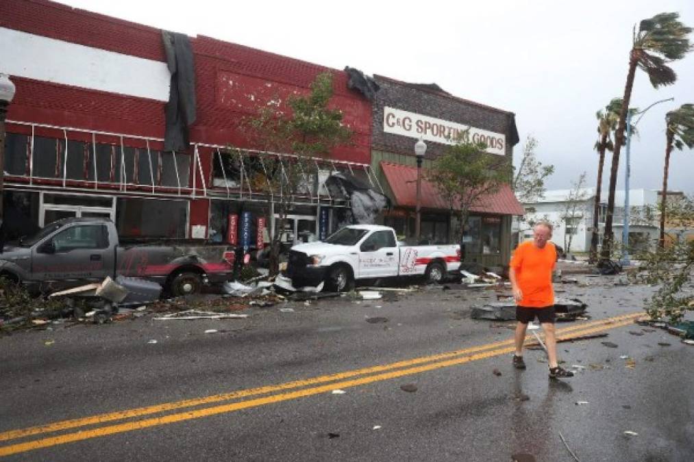 PANAMA CITY, FL - OCTOBER 10: Mike Hays walks past damaged stores after hurricane Michael passed through the downtown area on October 10, 2018 in Panama City, Florida. The hurricane hit the Florida Panhandle as a category 4 storm. Joe Raedle/Getty Images/AFP