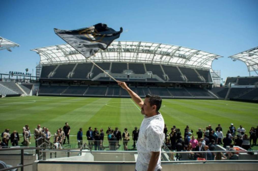'This is going to be my team from now on,' says Hugo Miranda, who lives 5 minutes from the Los Angeles Football Club's new Banc of California Stadium in Los Angeles, as he waves their flag during the unveiling of the new stadium on April 18, 2018. Miranda says he will be at the first game on April 29, the anniversary of the Los Angeles Riots, which he says disrupted his neighborhood. (Photo by Sarah Reingewirtz, Pasadena Star-News/SCNG)