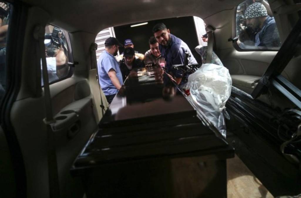 The coffin containing the remains of inmate Juan Ramon Alvarez Cruz, one of the victims of a shooting at the El Porvenir prison, is loaded onto a hearse at the morgue in Tegucigalpa, on December 23, 2019. - At least 36 people were killed in weekend clashes in Honduran prisons as the military and police try to regain control after a spate of murders linked to the criminal gangs plaguing the country. (Photo by STR / AFP)