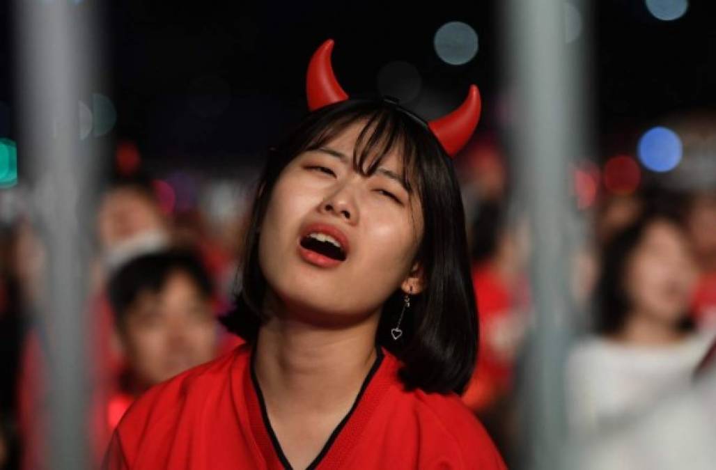 Una aficionada surcoreana llora tras el primer gol de México.