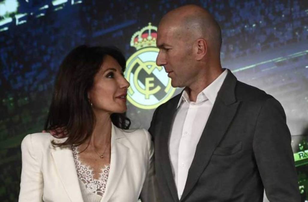 Real Madrid´s newly appointed French coach Zinedine Zidane poses with his wife Veronique after giving a press conference on March 11, 2019 in Madrid. - Zinedine Zidane has made a sensational return as coach of Real Madrid after Santiago Solari's sacking was finally confirmed. Zidane has been given a contract until June 2022, just nine months after he resigned at the end of last season, having led Madrid to an historic third consecutive Champions League triumph. (Photo by PIERRE-PHILIPPE MARCOU / AFP)