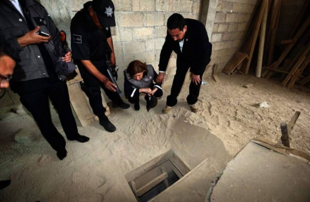 Joaquin 'El Chapo' Guzman, surrounded by US Marshals, waves to his wife as he enters the courtroom at Brooklyn Federal Court, as his high-security trial got underway in the Brooklyn borough of New York, Tuesday, Nov. 13, 2018. The infamous Mexican drug lord has been held in solitary confinement since his extradition to the United States early last year. Guzman pleaded not guilty to charges that he amassed a multi-billion-dollar fortune smuggling tons of cocaine and other drugs in a vast supply chain that reached New York, New Jersey, Texas and elsewhere north of the border. (Elizabeth Williams via AP)