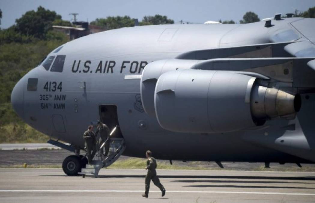 A US Air Force C-17 aircrafts carrying humanitarian aid for Venezuela is seen after landing at Camilo Daza International Airport in Cucuta, Colombia, on the border with Venezuela on February 16, 2019. - Venezuelan opposition leader Juan Guaido on Saturday called for nationwide protests next week to support volunteers planning to travel to the border with Colombia to bring in US humanitarian aid, the latest flashpoint in the country's political crisis. The announcement came as tons of US food aid was piling up along the border. It has been denounced by President Nicolas Maduro, who has asked the military to reinforce the frontier, denouncing the food as a 'booby trap' and a cover, he said, for a planned US military invasion. (Photo by Raul ARBOLEDA / AFP)