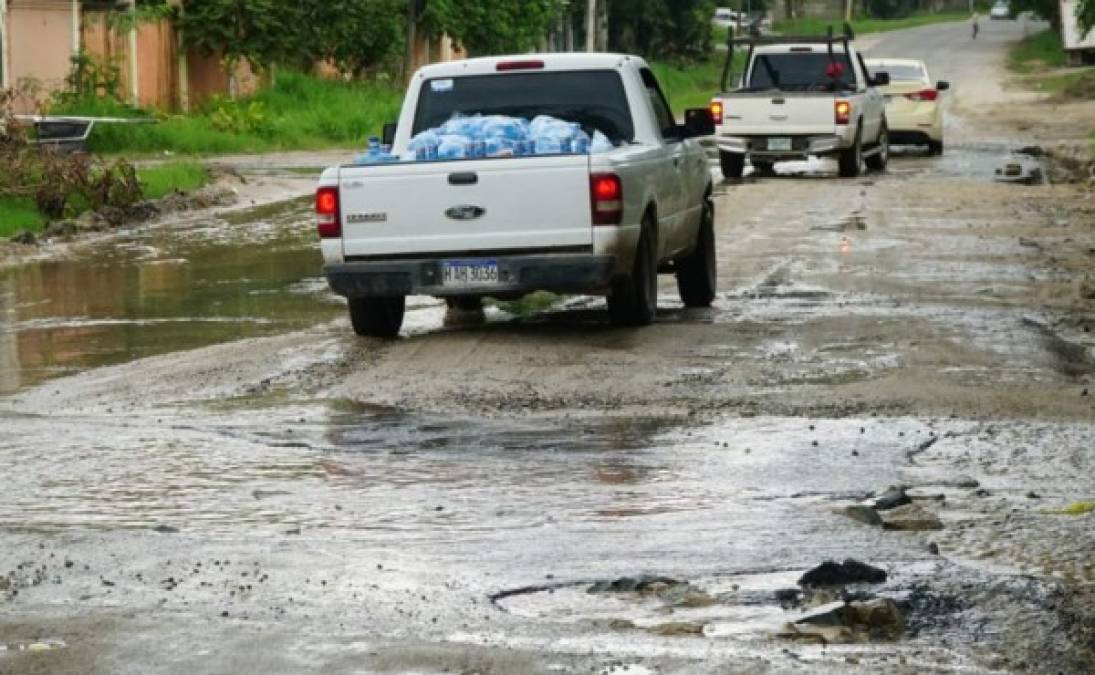 Frente a una de las colonias en contrucción se ha formado una poza debido a que se acumula agua y ha lavado el asfalto.