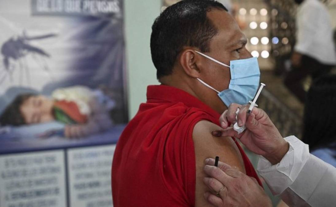 Una enfermera inocula a un hombre con una vacuna. Foto AFP