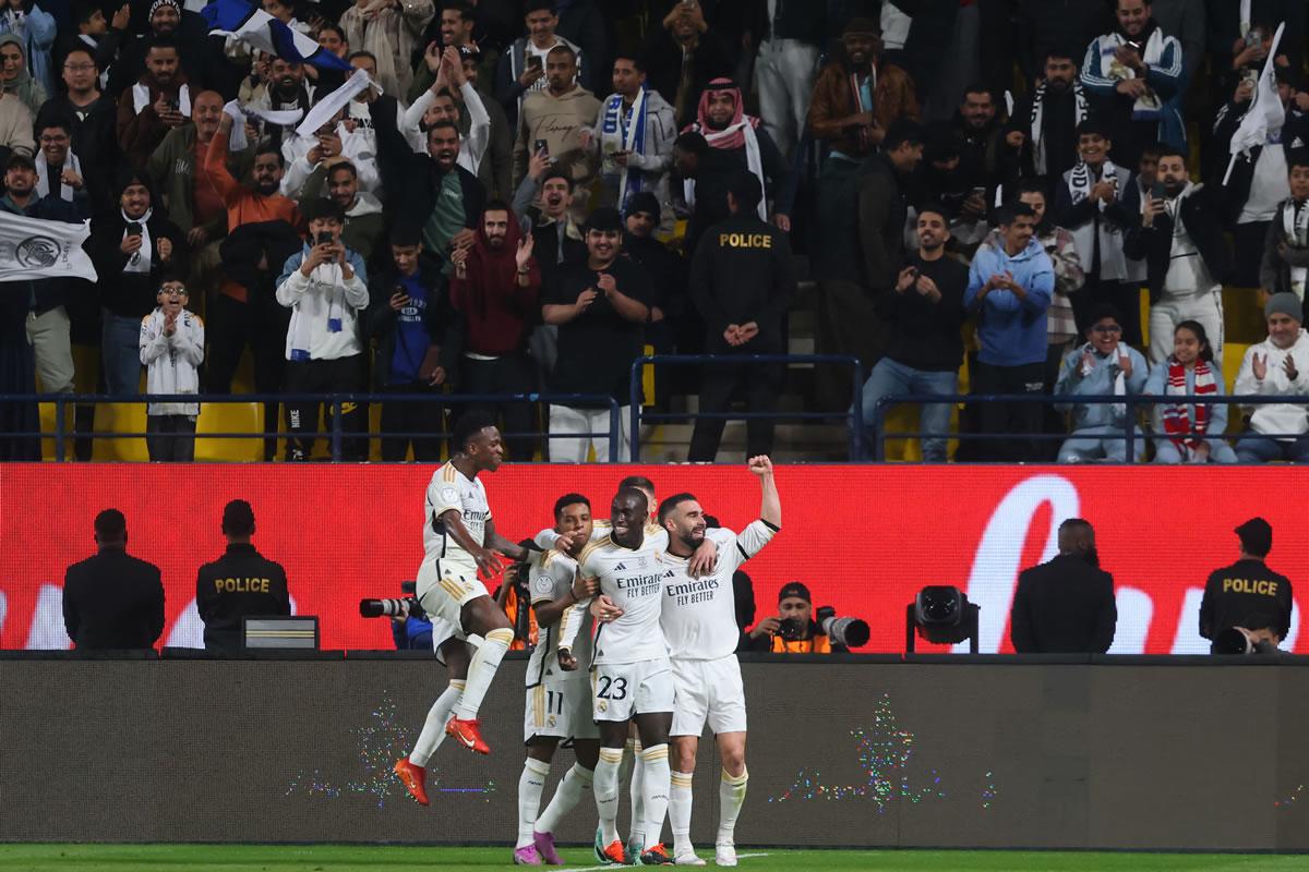 Los jugadores del Real Madrid festejando el gol de Ferland Mendy para el 2-1. Al fondo, los aficionados tomando fotos y celebrando.