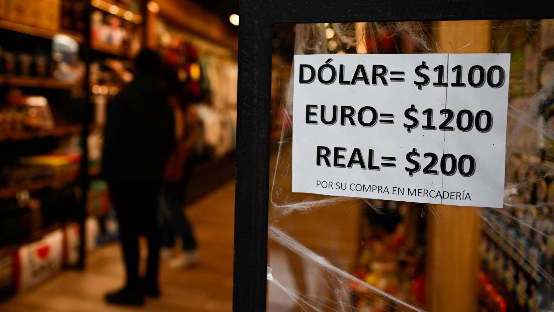 $!Un cartel con los valores de moneda de cambio del llamado “Dólar Azul” no oficial del mercado paralelo se muestra en el escaparate de una tienda en Buenos Aires el 24 de octubre de 2023. Argentina sufre por una inflación anual del 138%, una de las tasas de inflación más altas en el mundo.