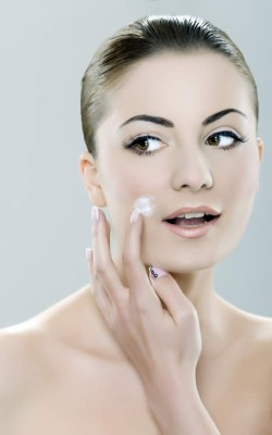 woman applying face cream.beauty treatment and spa.