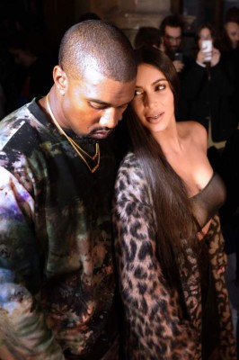 (FILES) This file photo taken on September 29, 2016 in Paris shows (From L) Kanye West and Kim Kardashian attending the Off-white 2017 Spring/Summer ready-to-wear collection fashion show. 16 people were arrested over Kardashian Paris robbery according police source, AFP reported on January 9, 2017. Kardashian was tied up and robbed of jewellery worth around nine million euros ($9.5 million) when a gang of masked men burst into the luxury Paris residence where she was staying during Fashion Week in October. / AFP PHOTO / ALAIN JOCARD