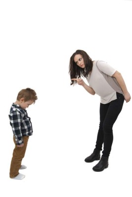 Young mother disciplining her young son isolated