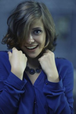 Portrait of a cheerful girl in a sexy blue