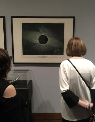 People look at a drawing by Etienne Leopold Trouvelot called 'Total Eclipse of the Sun' (1882)on July 1, 2019, part of a new exhibition by the Metropolitan Museum of Art in New York, to open on July 3, 2019, called 'Apollo's Muse: The Moon in the Age of Photography'. (Photo by Thomas URBAIN / AFP)