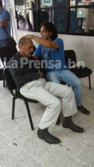El hijo brinda asistencia a su padre en el interior del Ministerio Público en la ciudad de San Pedro Sula.