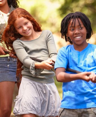 A group of kids in a tug-of-war game