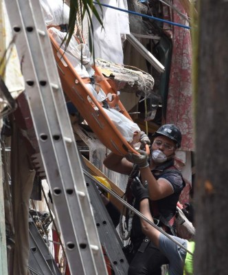 Rescuers carry a body pulled out of the rubble of a collapsed building in Mexico City on September 22, 2017 three days after a poweful quake hit central Mexico.A powerful 7.1 earthquake shook Mexico City on Tuesday, causing panic among the megalopolis' 20 million inhabitants on the 32nd anniversary of a devastating 1985 quake. / AFP PHOTO / Alfredo ESTRELLA