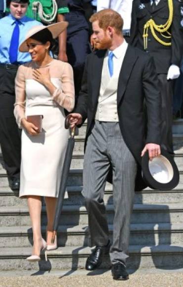 Britain's Prince Harry, Duke of Sussex (R), and his new wife, Britain's Meghan, Duchess of Sussex, attend the Prince of Wales's 70th Birthday Garden Party at Buckingham Palace in London on May 22, 2018.<br/>The Prince of Wales and The Duchess of Cornwall hosted a Garden Party to celebrate the work of The Prince's Charities in the year of Prince Charles's 70th Birthday. / AFP PHOTO / POOL / Dominic Lipinski