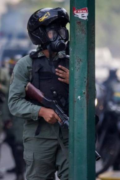 Un agente se enfrenta con manifestantes en Caracas.