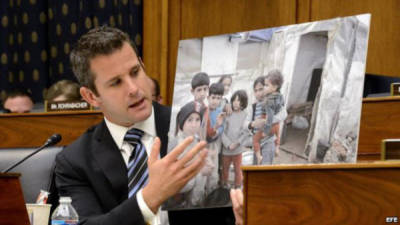 El congresista Republicano por Illinois, Adam Kinzinger, sostiene una fotografía de niños sirios que describe afectados por el gas sarín. EFE
