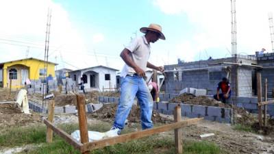 Obreros en construcción de casas sociales.