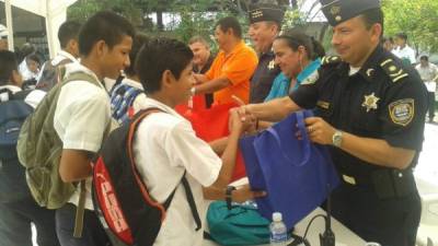 Miembros de la Policía Nacional entregaron las mochilas a los escolares en San Pedro Sula.