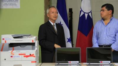 El cónsul Chan entrega las computadoras.