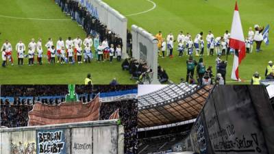 Una réplica impresionante del Muro de Berlín se desplegó este sábado a lo largo de la línea media del estadio Olímpico de Berlín, para conmemorar el 30º aniversario de su caída. Fotos AFP y EFE