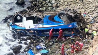 El autobús, que había partido hacia Lima con 55 pasajeros y dos tripulantes desde la ciudad de Huacho, quedó volcado a metros del mar. AFP