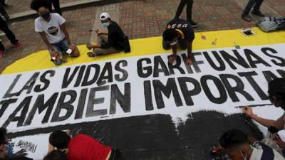 Imagen de archivo de garífunas protestando con pancartas y reclamando su liberación.