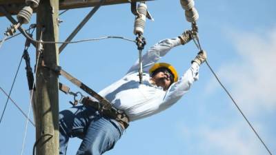 Cuadrillas de la Enee trabajan en el mantenimiento de postes eléctricos en Tegucigalpa.