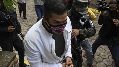 Momento en que el empresario David Castillo era trasladados a los juzgados de Tegucigalpa. Foto AFP