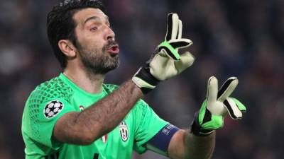 Juventus' Italian goalkeeper Gianluigi Buffon (L) argues with the referee during the UEFA Champions League quarter-final second leg football match between Real Madrid CF and Juventus FC at the Santiago Bernabeu stadium in Madrid on April 11, 2018. / AFP PHOTO / OSCAR DEL POZO