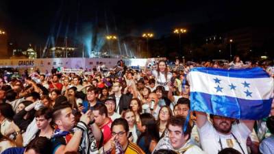 Este aficionado del Real Madrid alzó la bandera de Honduras en los festejos en la Plaza Cibeles. Foto AFP