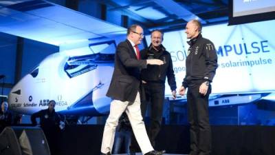 El piloto y director general de Solar Impulse, Andre Borschberg (c) y el presidente fundador y piloto Bertrand Piccard (dcha), saludan al padrino, el príncipe Alberto de Mónaco, durante la presentación del segundo prototipo del primer avión solar.