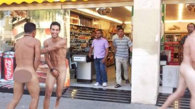 Un grupo de turistas italianos, desnudos, saliendo de un supermercado- (VICENS FORNER)