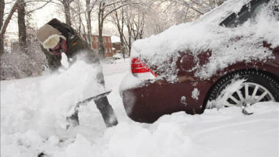 Un hombre quita la nieve de su coche en las calles de Indianápolis, Indiana, Estados Unidos, en donde según medios locales ha caído una nevada de 30 centímetros y las temperaturas han llegado a los menos nueve grados. EFE