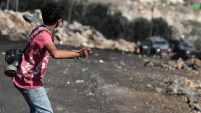 Un adolescente usa una honda para enfrentarse a los policías en la localidad de Kfar Qaddum, al norte de Cisjordania.