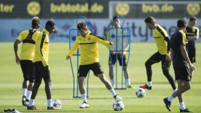 El delantero francés del Borussia Dortmund Ousmane Dembelé (i) y el lateral portugués Raphael Guerreiro (c) asisten a una sesión de entrenamientos en Dortmund, Alemania, hoy, 26 de septiembre de 2016. EFE