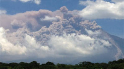 In this image with a cell phone, plumes of smoke rise from the Volcan de Fuego or Volcano of Fire as seen from Palin, south of Guatemala City, Thursday, Sept. 13, 2012. The volcano is spewing lava and ash and the director of the national disaster agency says officials are carrying out a massive evacuation of thousands of people in five communities. (AP Photo/Moises Castillo)
